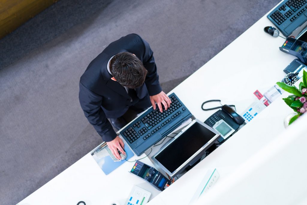 Top view of a male hotel receptionist on the phone