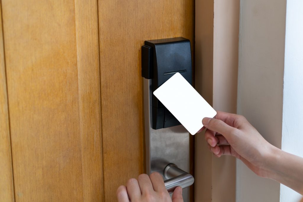 Door access control - woman hand holding white mockup key card t