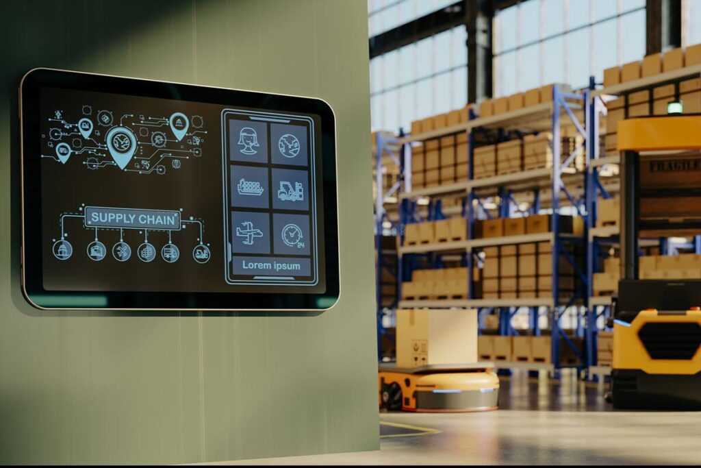 Digital supply chain management screen displayed inside an automated warehouse with storage racks and mobile robots