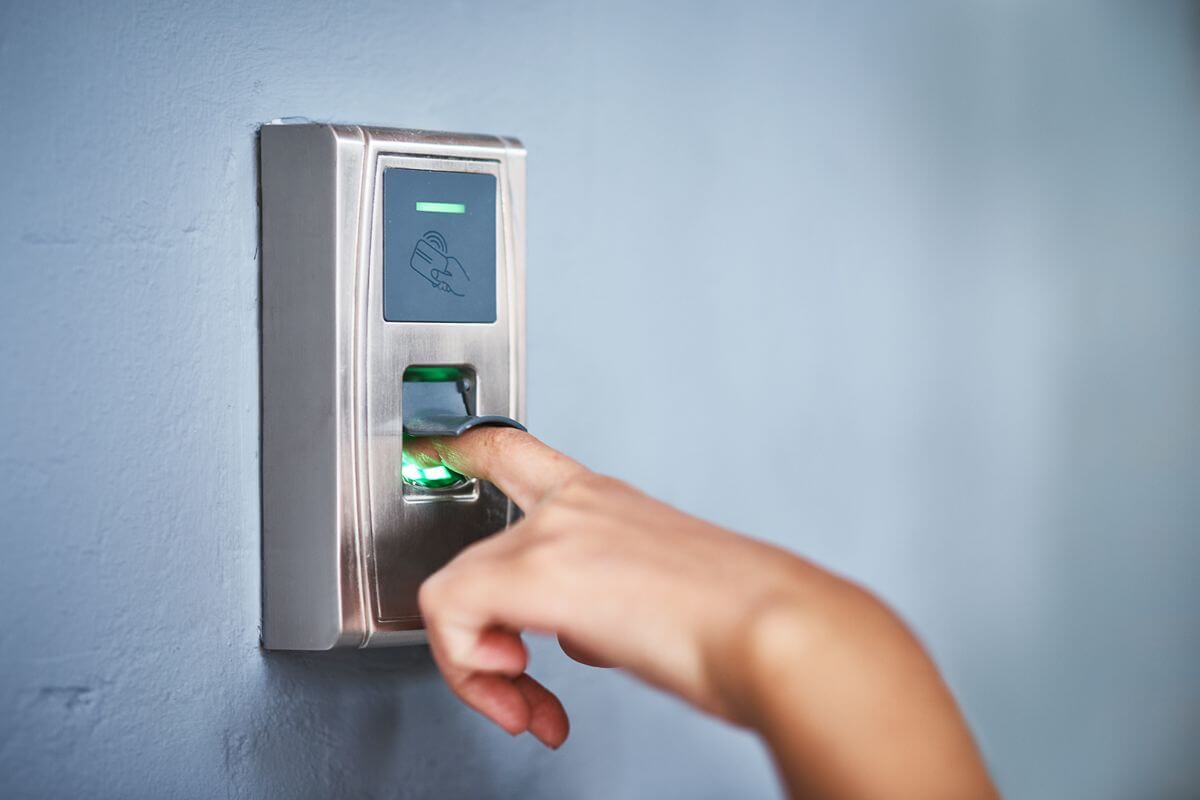 Finger being scanned by a biometric door access reader