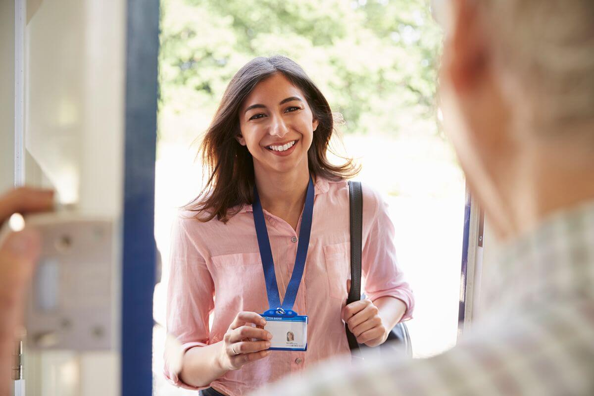 Registered visitor presenting an identification badge upon arrival at a modern building