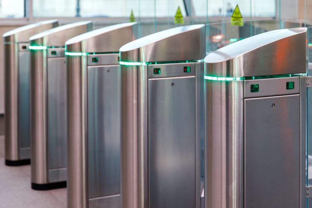 Automated access control turnstiles securing the entrance of a modern commercial building